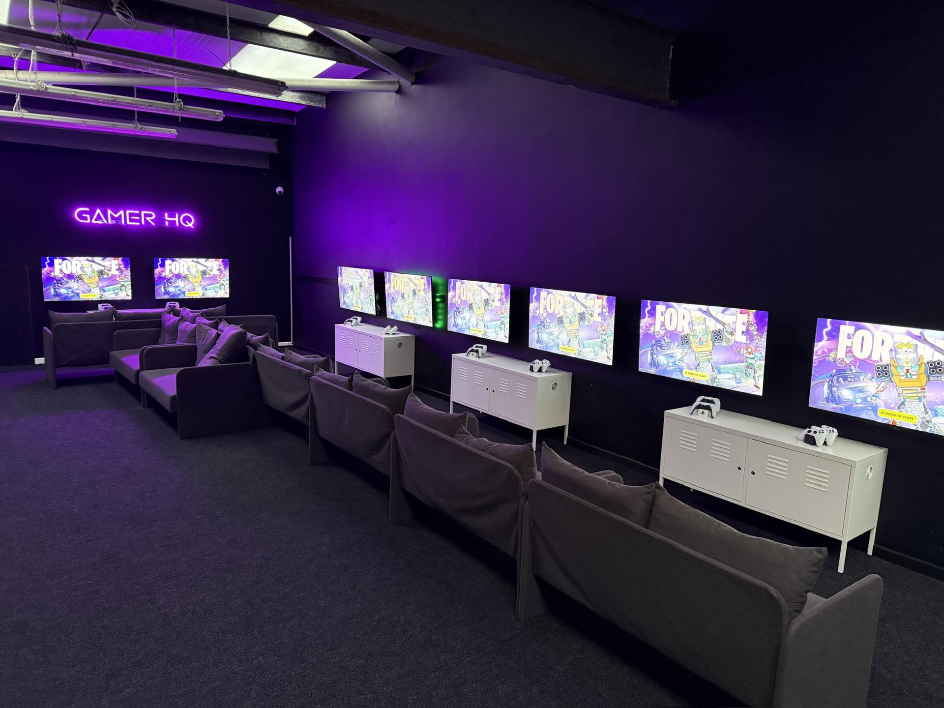 The Gamer HQ lounge lit in purple neon